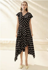 Silk polka dot dress with cowl neckline and asymmetrical hem for a playful feminine look